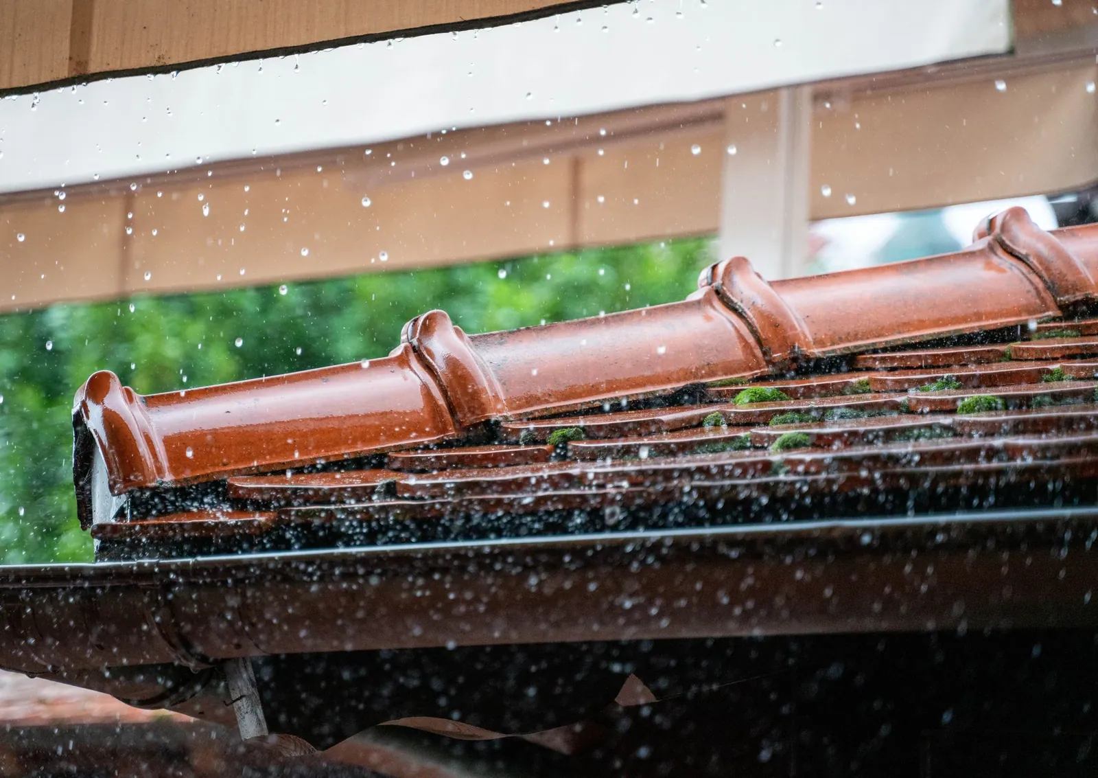 Rain falling from a terracotta roof